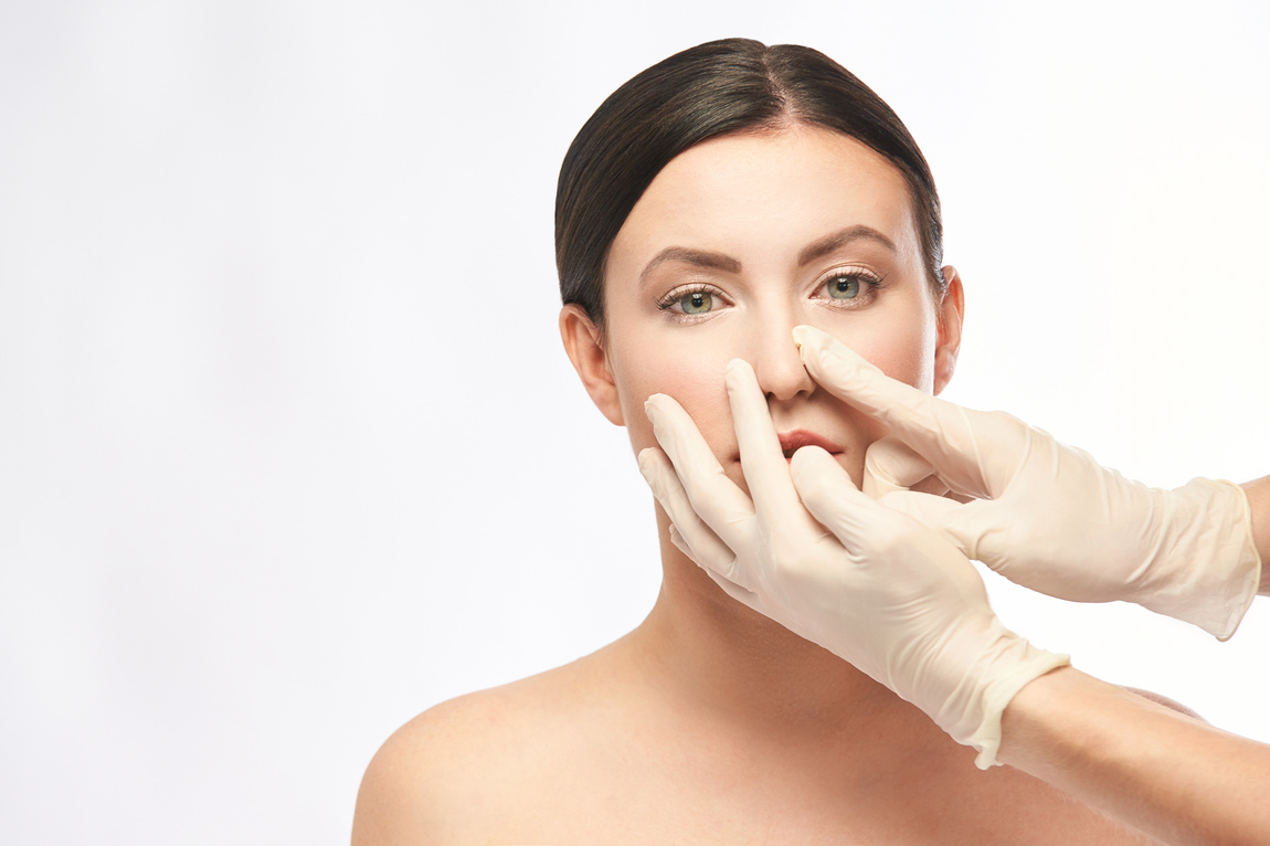 Hands in Gloves Touching Woman's Face